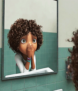 Surprised black girl at the bathroom mirror GIF